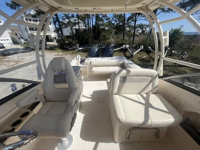 Slide: The Image of 2016 Grady-White Freedom 275 boat interior with seating and dual engines. - 10