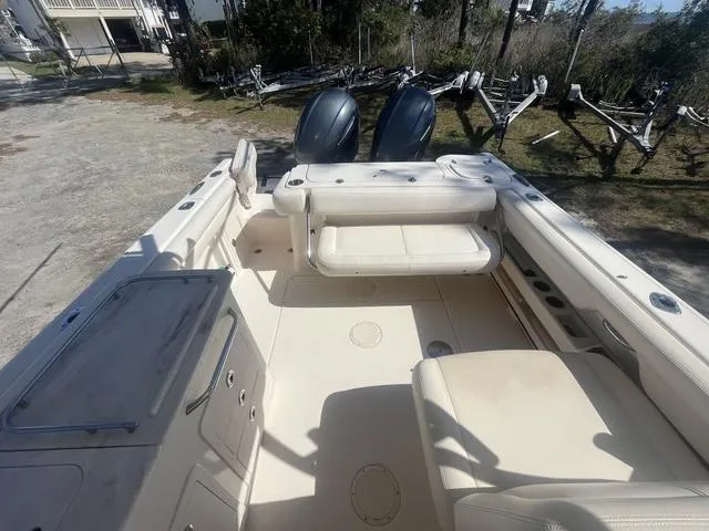 Slide: The Image of 2016 Grady-White Freedom 275 boat interior with seating and dual engines. - 12