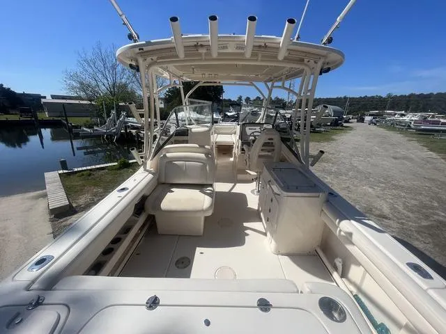 Slide: The Image of 2016 Grady-White Freedom 275 boat interior, featuring spacious seating and fishing rod holders. - 14