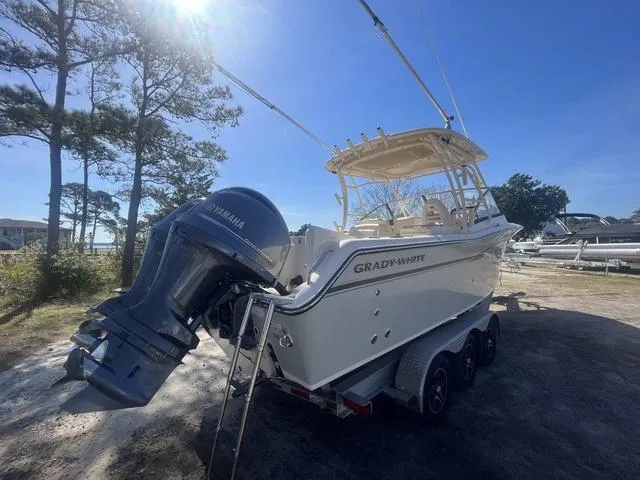 Slide: The Image of 2016 Grady-White Freedom 275 boat with Yamaha engine on a trailer, parked outdoors. - 6
