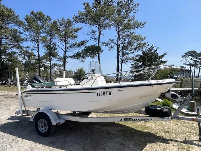Slide: The Image of 1999 Boston Whaler 160 Dauntless boat on EZ Loader trailer, parked outdoors. - 1