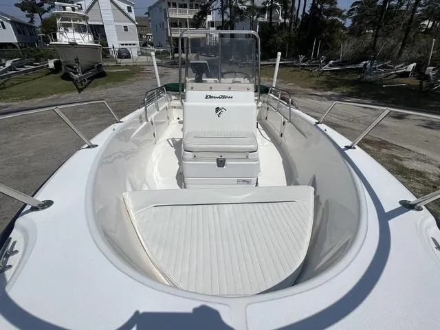 Slide: The Image of 1999 Boston Whaler 160 Dauntless boat, white interior, parked outdoors, surrounded by trees and houses. - 7