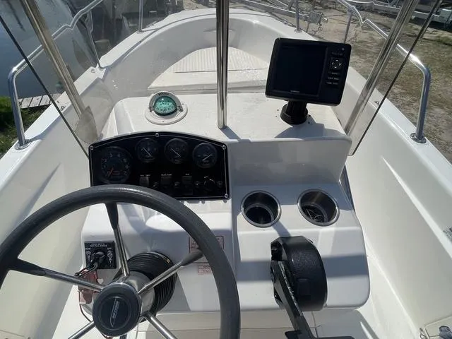 Slide: The Image of 1999 Boston Whaler 160 Dauntless boat console with steering wheel, gauges, and navigation equipment. - 9