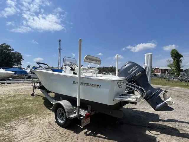 Slide: The Image of 2017 Sportsman 17' Island Reef boat on trailer, Yamaha motor, parked outdoors under blue sky. - 3