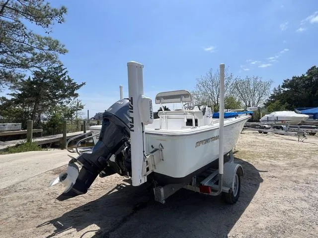 Slide: The Image of 2017 Sportsman 17' Island Reef boat on trailer, parked outdoors under clear sky. - 5