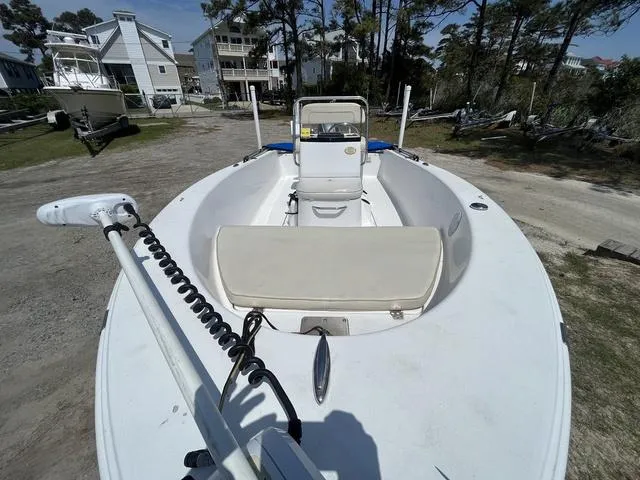 Slide: The Image of 2017 Sportsman 17' Island Reef boat on land, surrounded by trees and houses. - 6