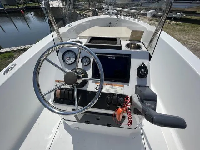 Slide: The Image of 2017 Sportsman 17' Island Reef boat console with steering wheel and navigation equipment. - 8