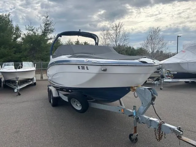 Slide: The Image of 2018 Yamaha Boats 242 Limited S on trailer, parked outdoors under cloudy sky. - 3