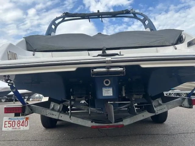 Slide: The Image of 2018 Yamaha Boats 242 Limited S on trailer, rear view, under cloudy sky. - 6