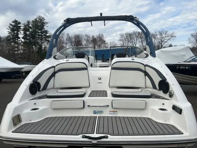 Slide: The Image of 2018 Yamaha Boats 242 Limited S, rear view, showcasing spacious seating and sleek design. - 7