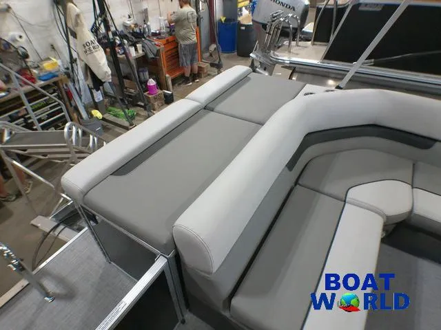 Slide: The Image of 2025 Princecraft Vectra 21 Cruise Lounge interior with gray seating in a workshop setting. - 17