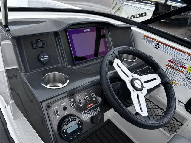 Slide: The Image of 2021 Bayliner VR6 Bowrider dashboard with steering wheel and control panel. - 10