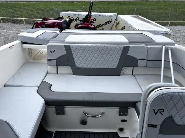 Slide: The Image of 2021 Bayliner VR6 Bowrider interior with gray seating and quilted design. - 15