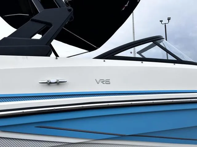 Slide: The Image of 2021 Bayliner VR6 Bowrider boat, sleek design with blue and white exterior. - 3