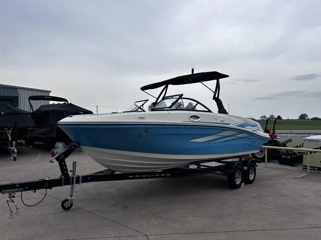 Slide: The Image of 2021 Bayliner VR6 Bowrider boat on trailer, blue and white design, parked outdoors. - 6