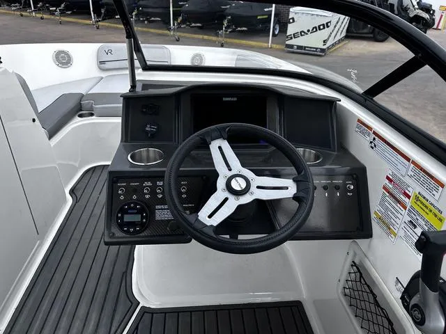 Slide: The Image of 2021 Bayliner VR6 Bowrider dashboard with steering wheel and controls. - 9