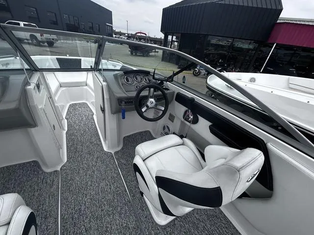 Slide: The Image of 2018 Chaparral 21 H2O Sport I/O boat interior with steering wheel and seating. - 10