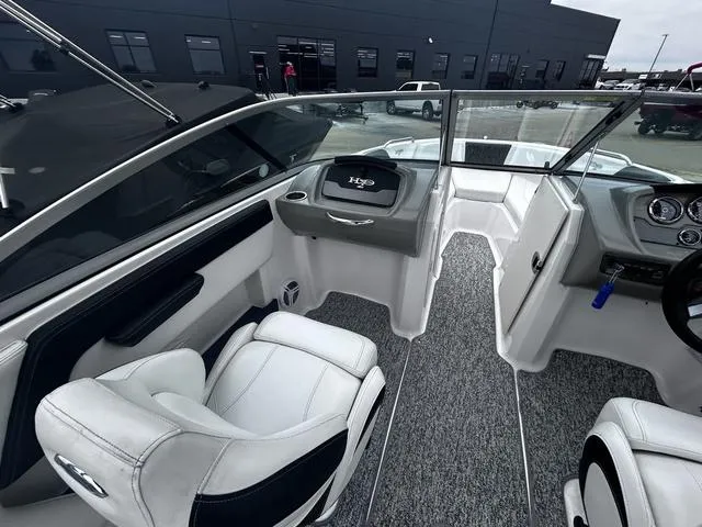 Slide: The Image of 2018 Chaparral 21 H2O Sport I/O boat interior with white seating and modern dashboard. - 11