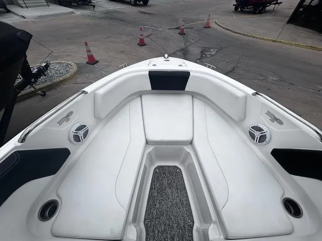 Slide: The Image of 2018 Chaparral 21 H2O Sport I/O boat interior with white seating and speakers. - 13