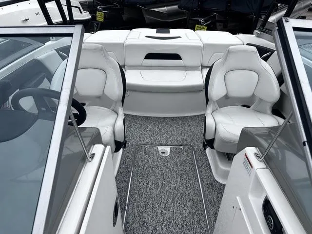 Slide: The Image of 2018 Chaparral 21 H2O Sport I/O boat interior with white seating and gray carpet. - 14
