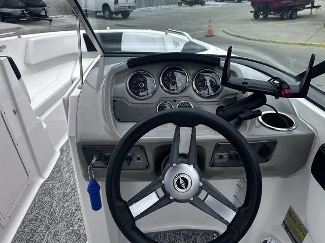 Slide: The Image of 2018 Chaparral 21 H2O Sport I/O boat dashboard with steering wheel and gauges. - 16