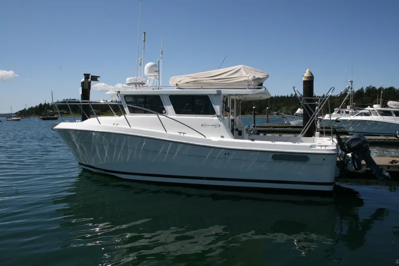 The Image of 2011 Ocean Sport Roamer 30' boat docked in a serene marina setting. - 0