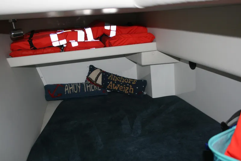 Slide: The Image of Cozy cabin interior of 2011 Ocean Sport Roamer 30' with life jackets and nautical pillows. - 12