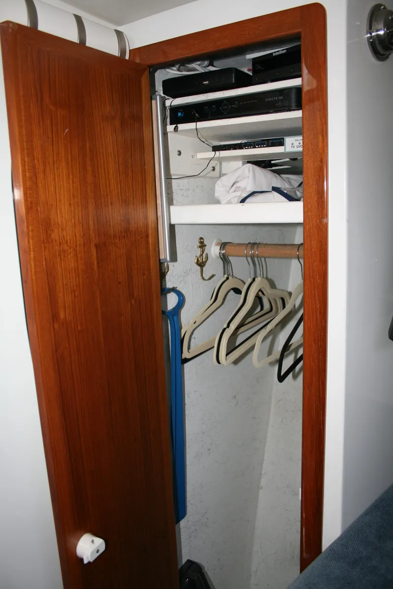 Slide: The Image of Wooden closet interior on 2011 Ocean Sport Roamer 30' boat with hangers and shelves. - 17