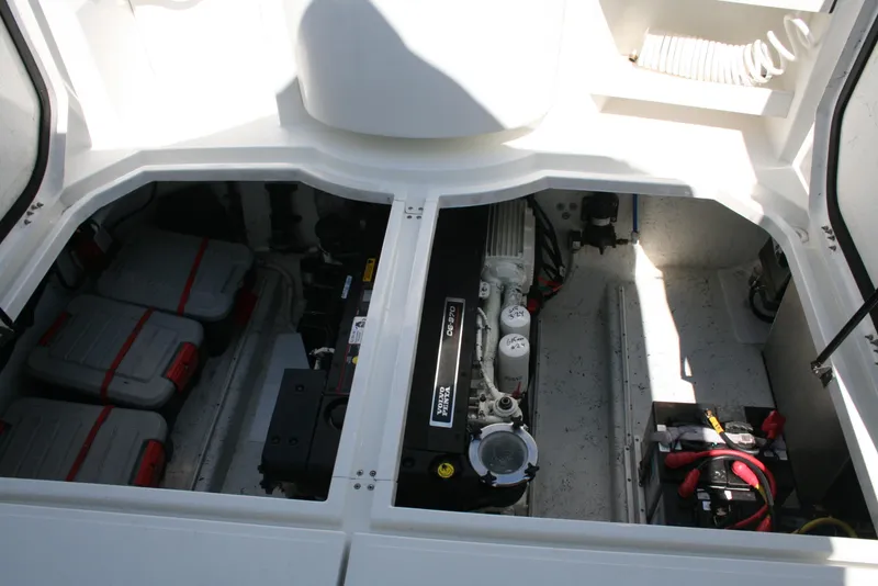 Slide: The Image of Engine compartment of a 2011 Ocean Sport Roamer 30' boat, showcasing batteries and engine components. - 18