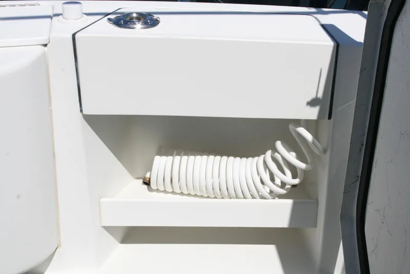 Slide: The Image of Coiled hose storage on 2011 Ocean Sport Roamer 30' boat. - 19