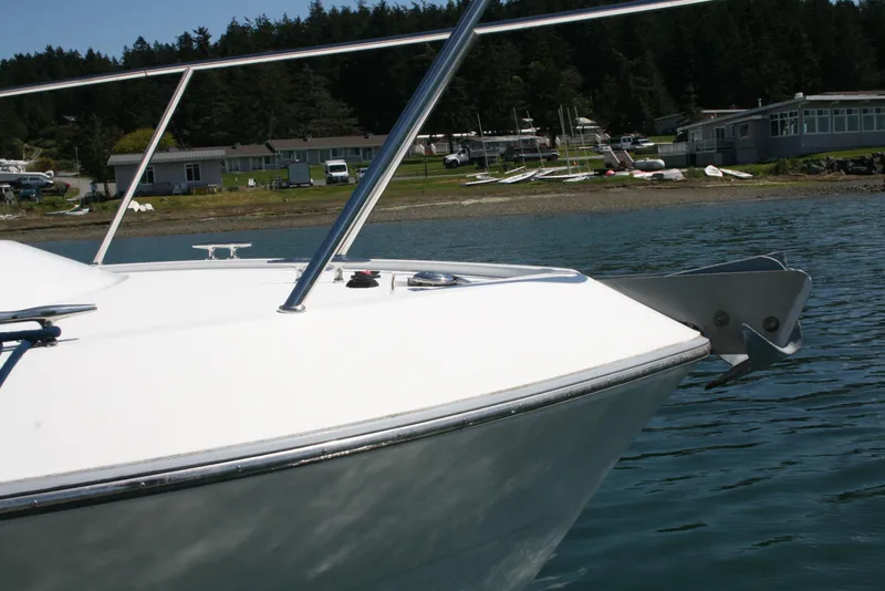 Slide: The Image of 2011 Ocean Sport Roamer 30' boat anchored near a scenic shoreline. - 24