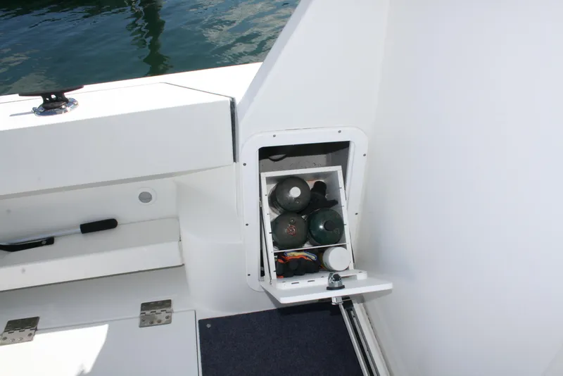 Slide: The Image of Storage compartment on 2011 Ocean Sport Roamer 30' boat, open with visible contents. - 3