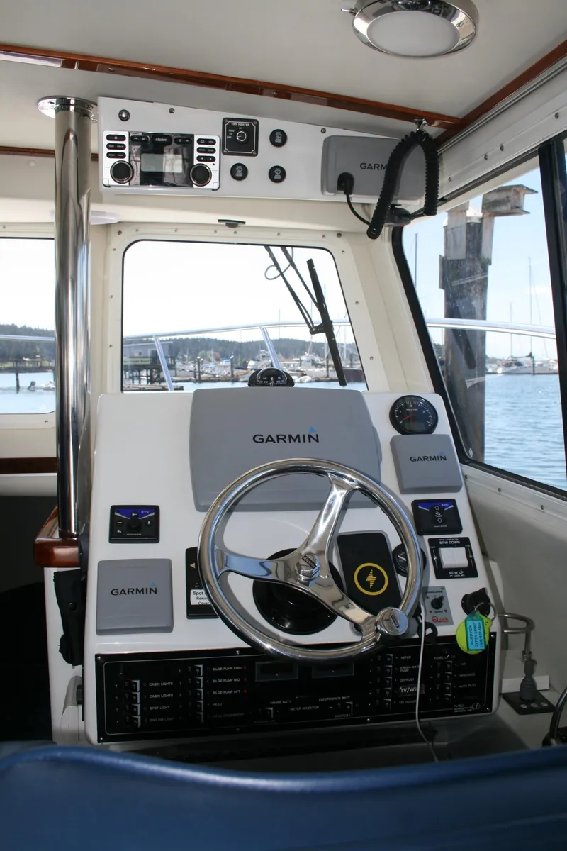Slide: The Image of Cockpit of 2011 Ocean Sport Roamer 30' with Garmin navigation system and steering wheel. - 5