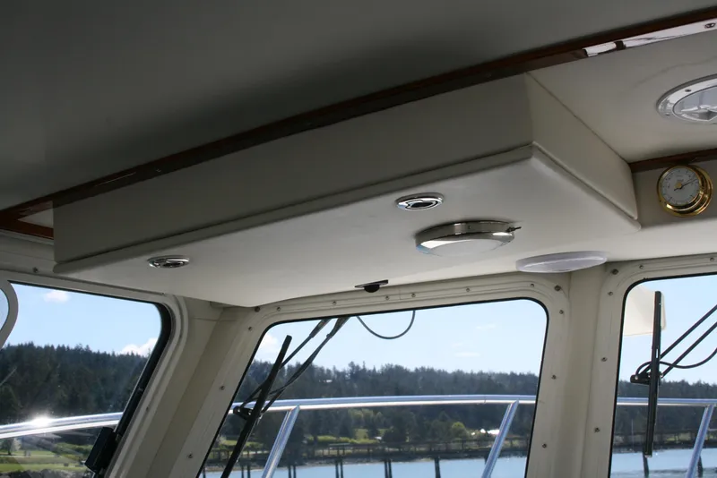 Slide: The Image of Interior view of 2011 Ocean Sport Roamer 30' boat with windows and ceiling details. - 9