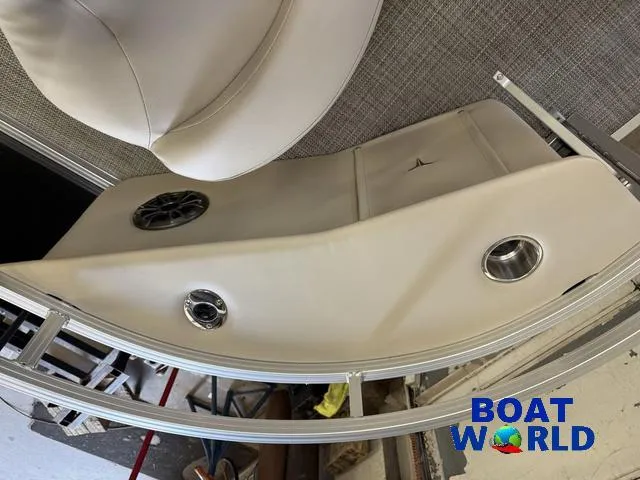 Slide: The Image of 2025 Tahoe Sport 2185 Quad Fish boat interior with speaker and cup holder, Boat World logo. - 10