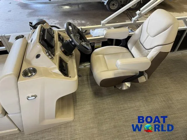 Slide: The Image of 2025 Tahoe Sport 2185 Quad Fish boat interior with steering console and captain's chair. - 15
