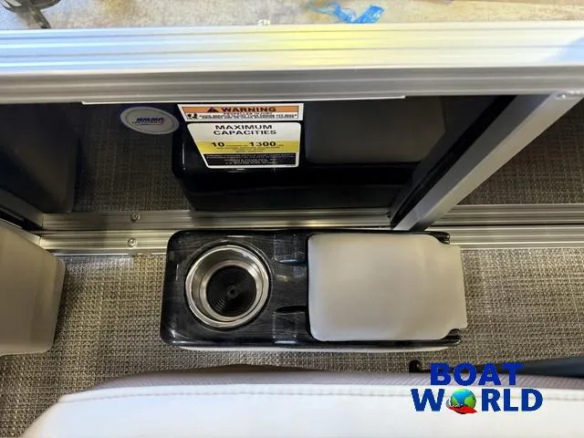 Slide: The Image of 2025 Tahoe Sport 2185 Quad Fish interior with cup holder and capacity warning label. - 20