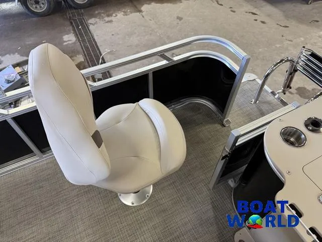 Slide: The Image of 2025 Tahoe Sport 2185 Quad Fish boat interior with swivel chair and control panel. - 24