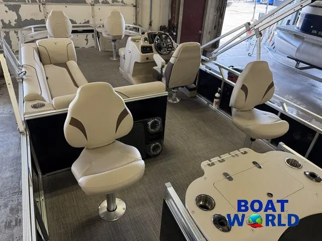 Slide: The Image of 2025 Tahoe Sport 2185 Quad Fish interior with seating and steering console, showcased at Boat World. - 27