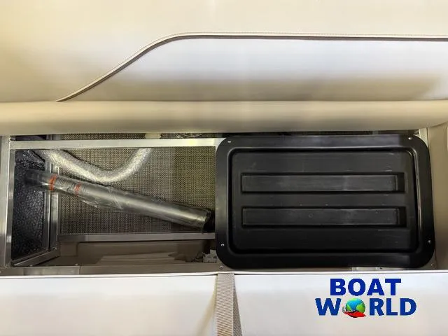 Slide: The Image of 2025 Tahoe Sport 2185 Quad Fish storage compartment with ventilation and black cover. - 29