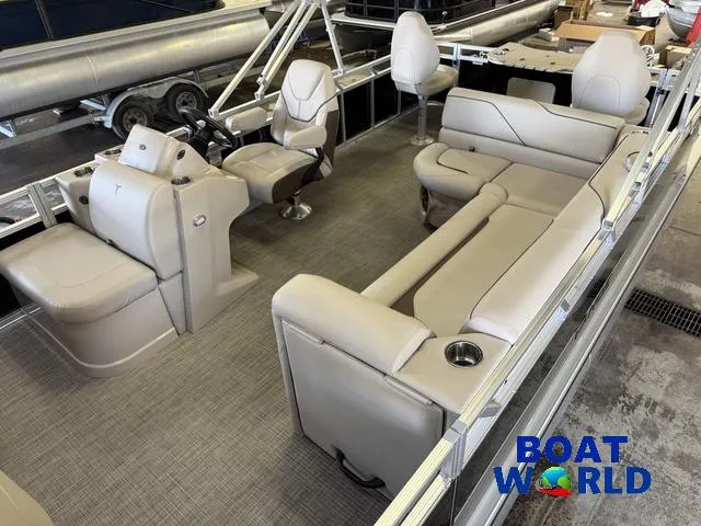Slide: The Image of 2025 Tahoe Sport 2185 Quad Fish boat interior with beige seating and steering console. - 4