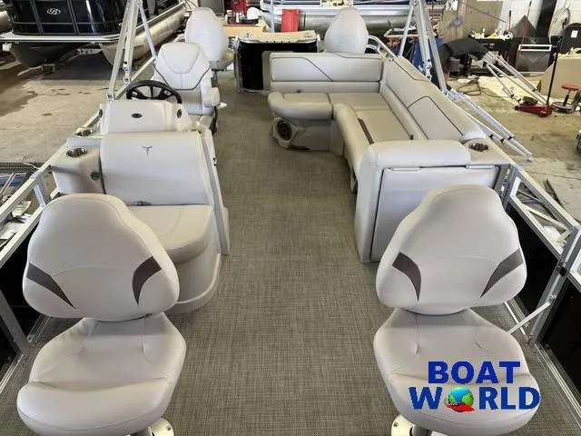 Slide: The Image of 2025 Tahoe Sport 2185 Quad Fish boat interior with seating and steering wheel, showcased at Boat World. - 6