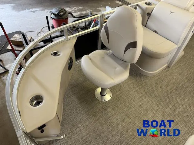 Slide: The Image of 2025 Tahoe Sport 2185 Quad Fish interior with seating and cup holders, showcased at Boat World. - 7
