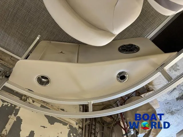 Slide: The Image of 2025 Tahoe Sport 2185 Quad Fish boat interior with cup holders and speaker, Boat World logo. - 9