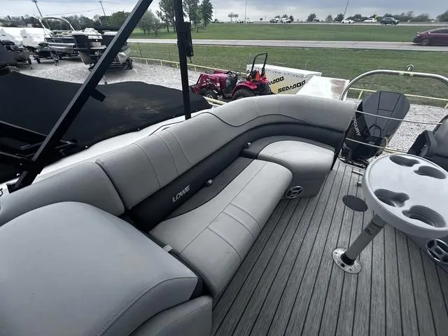 Slide: The Image of 2020 Lowe SS250 WS WindShield boat with gray seating and deck, parked outdoors. - 13
