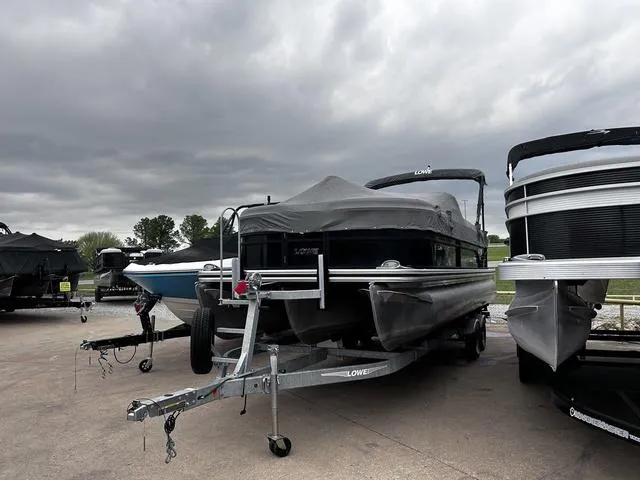 Slide: The Image of 2020 Lowe SS250 WS WindShield boat on trailer under cloudy sky. - 18