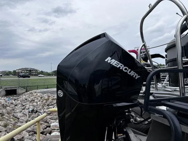 Slide: The Image of 2020 Lowe SS250 WS WindShield boat with Mercury engine, parked near rocky shoreline. - 5