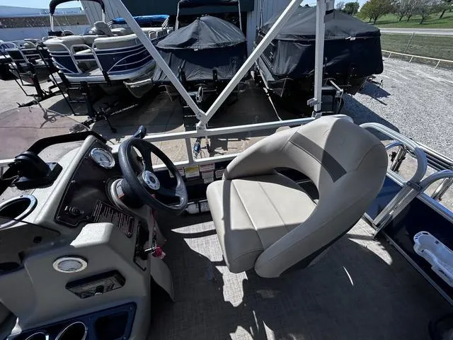 Slide: The Image of 2023 Sun Tracker Bass Buggy® 16 XL Select boat interior with steering wheel and captain's chair. - 11
