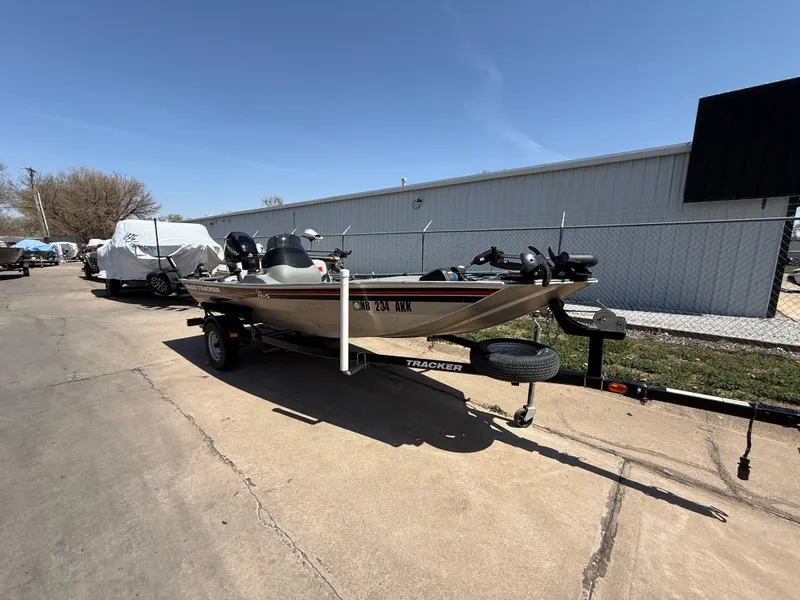 Slide: The Image of 2011 Tracker Pro 165 boat on trailer, parked outdoors under clear sky. - 3