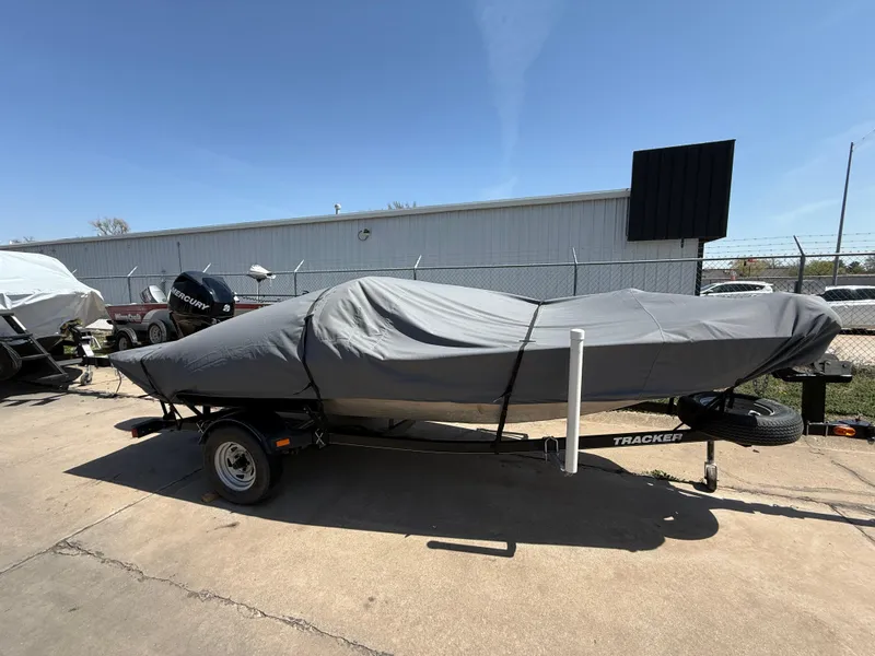 Slide: The Image of 2011 Tracker Pro 165 boat covered on trailer, parked outdoors. - 5